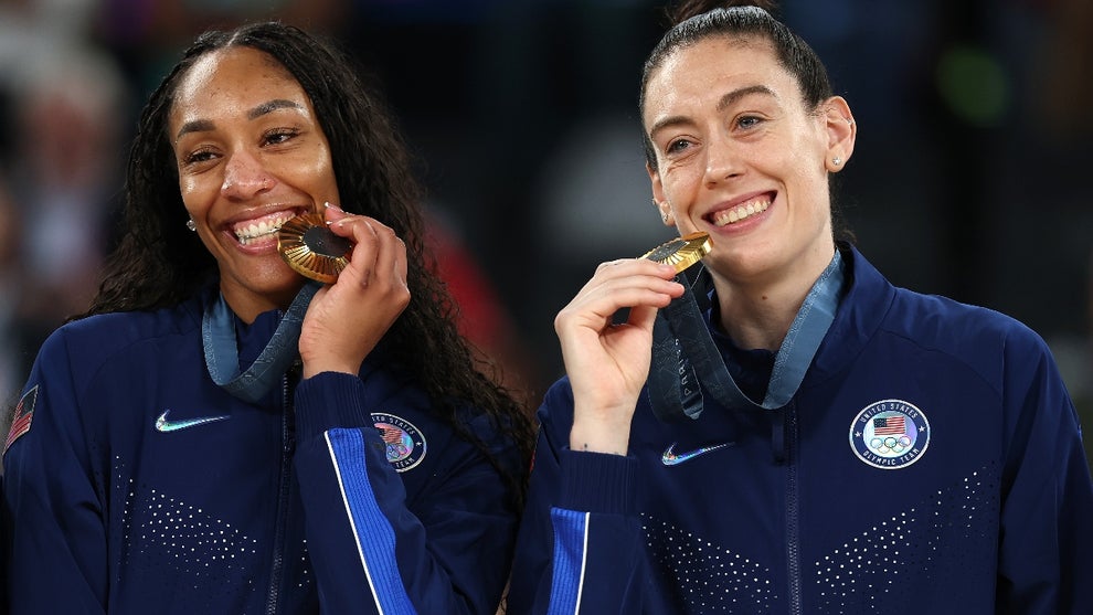 Gold medalists A'Ja Wilson #9 and Breanna Stewart #10 of Team United States poses for a photo while on the podium during the Women's basketball medal ceremony on day sixteen of the Olympic Games Paris 2024 at Bercy Arena on August 11, 2024 in Paris, France.