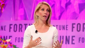 Dana Bash gestures with her hands on stage in front of a pink backdrop reading "Fortune."
