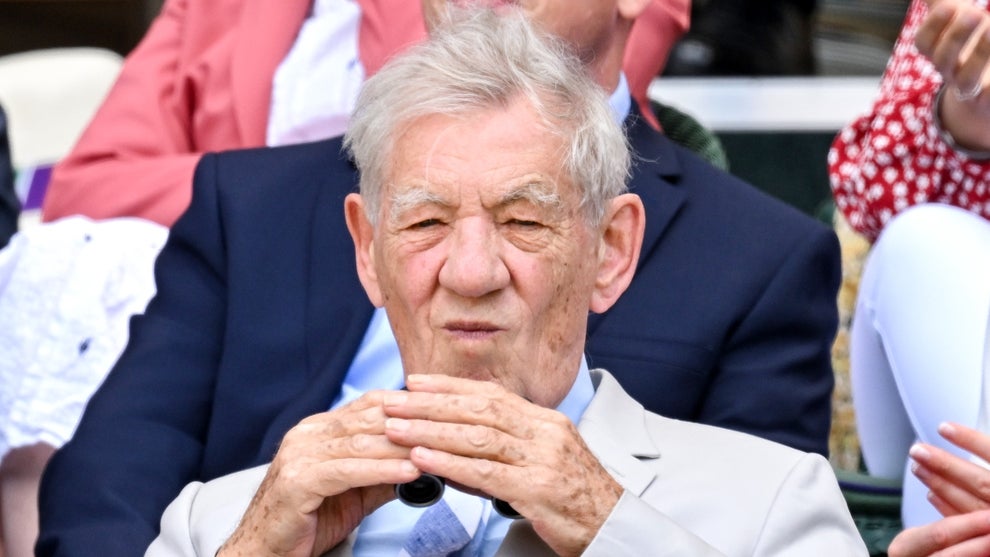 Sir Ian McKellen looks through a pair of binoculars during Day Eight of the Wimbledon Tennis Championships 2022 at All England Lawn Tennis and Croquet Club on July 04, 2022 in London, England