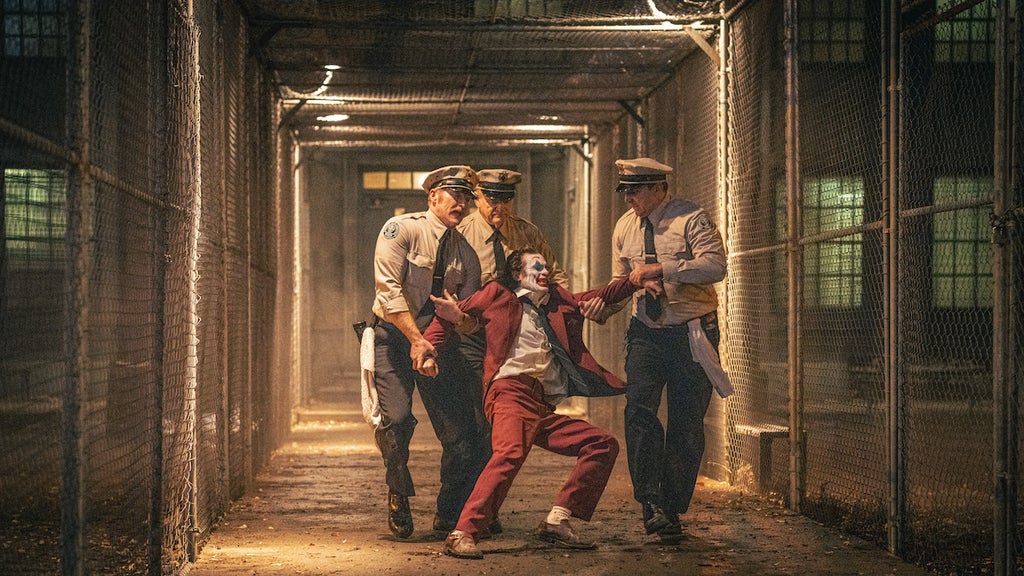 Brendan Gleeson as Jackie Sullivan and Joaquin Phoenix as Arthur Fleck in "Joker: Folie à Deux" (Credit: Warner Bros. Pictures)