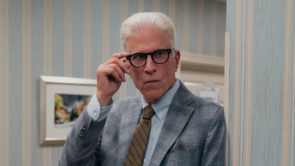 Ted Danson grips the edge of his glasses in an investigative manner and peers around a corner in "A Man on the Inside"