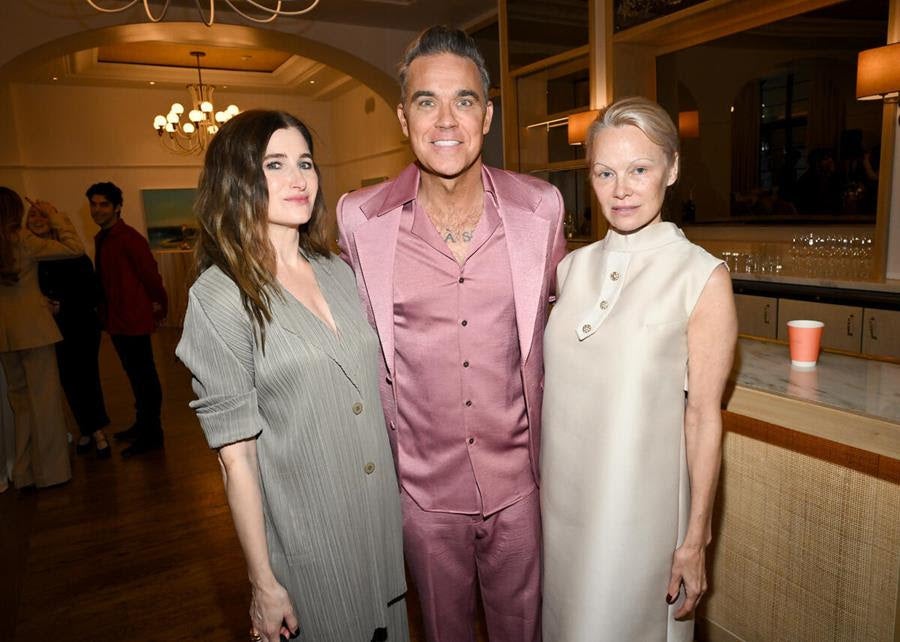 Kathryn Hahn, Robbie Williams and Pamela Anderson (Source: Michael Buckner /PMC for Golden Globes)
