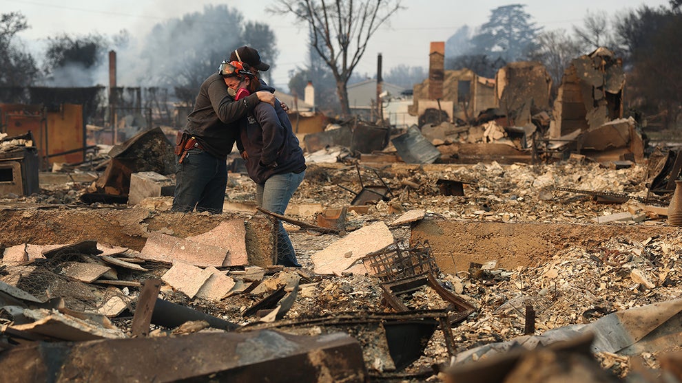 Khaled Fouad and Mimi Laine embrace as they inspect a family member's property that was destroyed by Eaton Fire (Credit: Justin Sullivan/Getty Images)