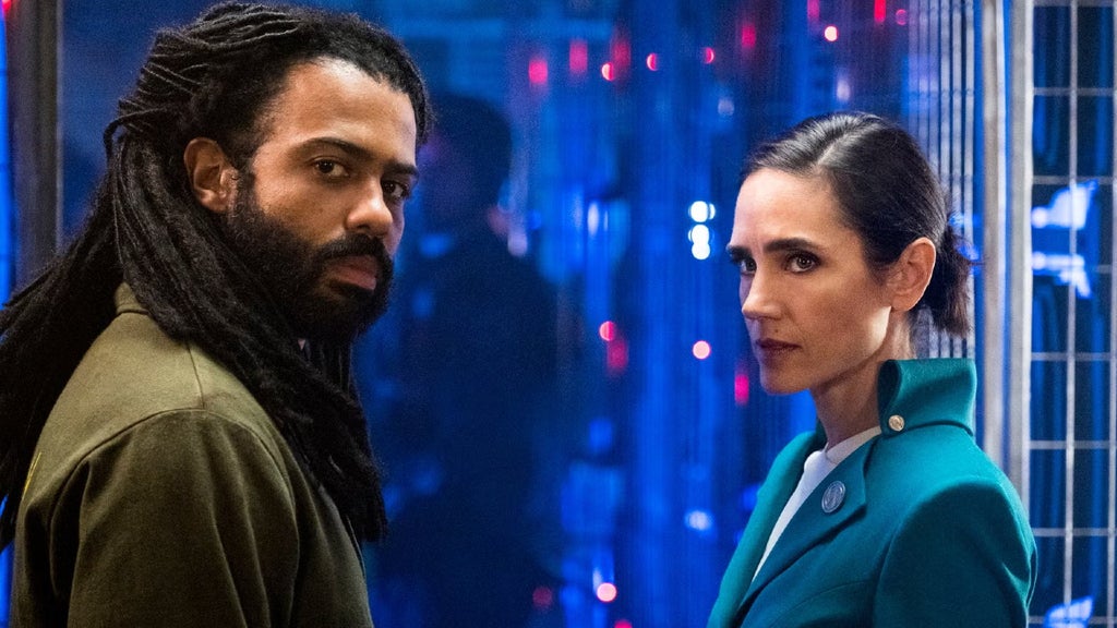 Daveed Diggs and Jennifer Connelly stand next to each other in "Snowpiercer."