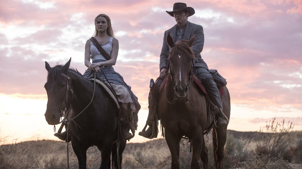 Evan Rachel Wood and James Marsden sit on horses in "Westworld."