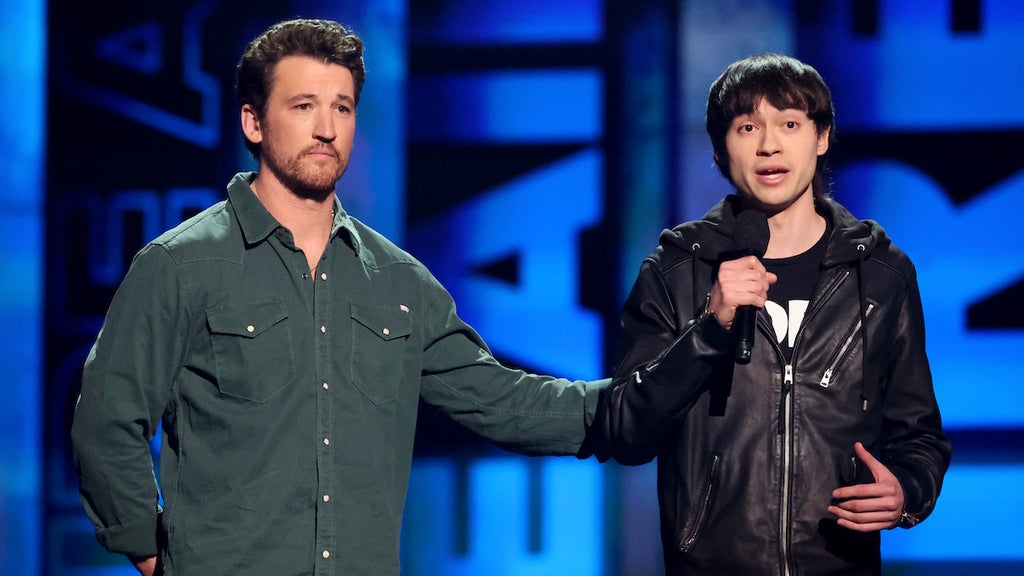 Miles Teller and Chad Comey speak on stage after both losing their homes in the Palisades fire. (Credit: Amy Sussman/Getty Images)