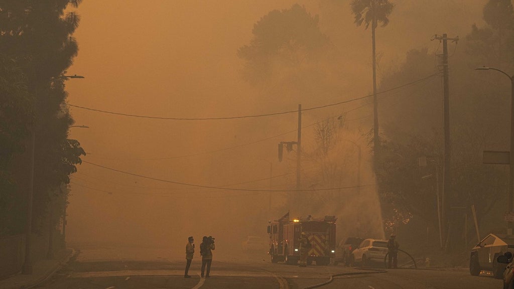 Torrance Firefighters are seen gearing up to fight the Palisades Fire. (Credit: Anadolu/Getty Images)