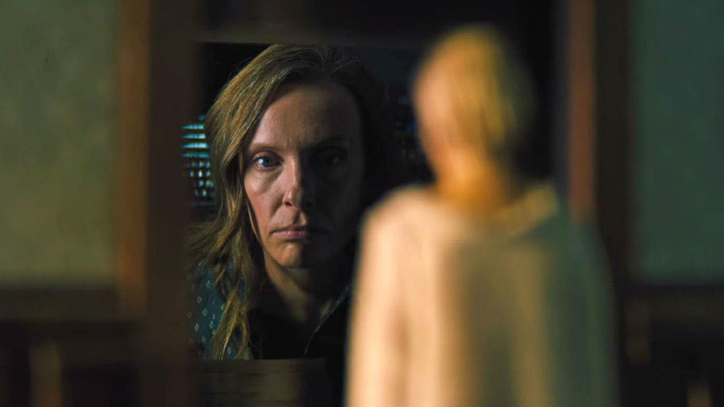 Toni Collette looks at a miniature in "Hereditary."