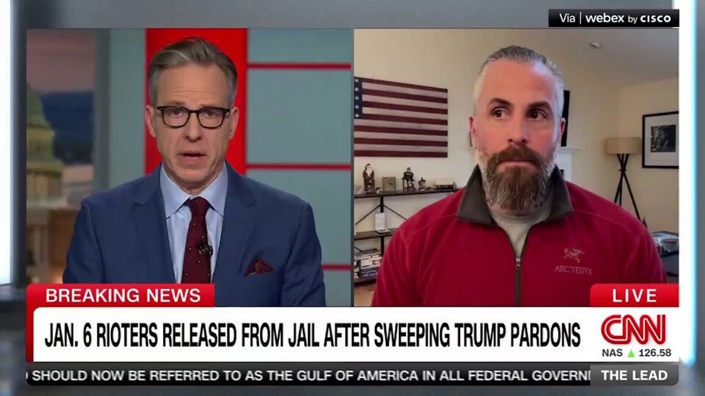 Jake Tapper and former Capitol Hill police officer Michael Fanone
