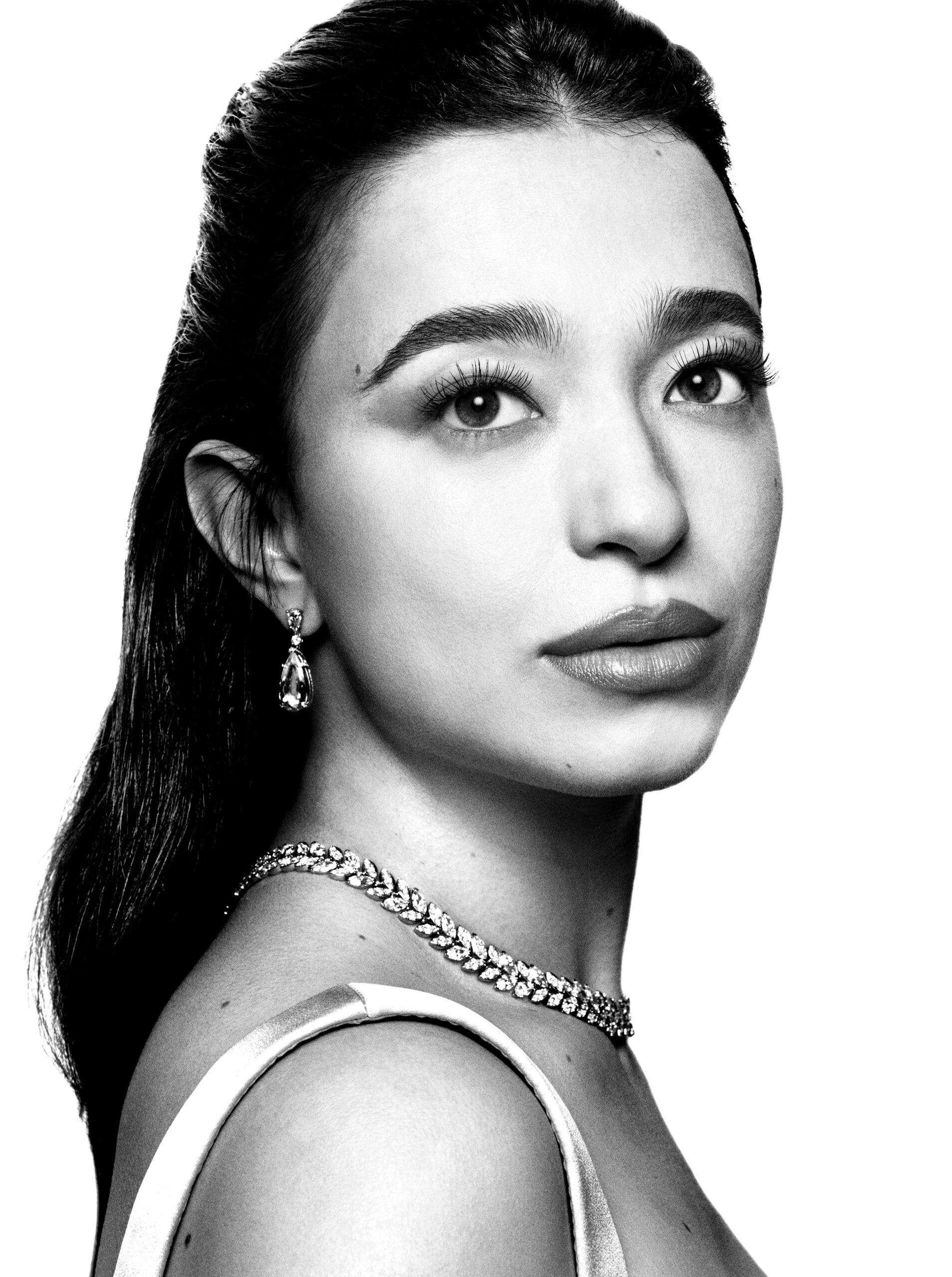 Mikey wears earrings and necklace, both by Tiffany & Co, and dress by miu miu.