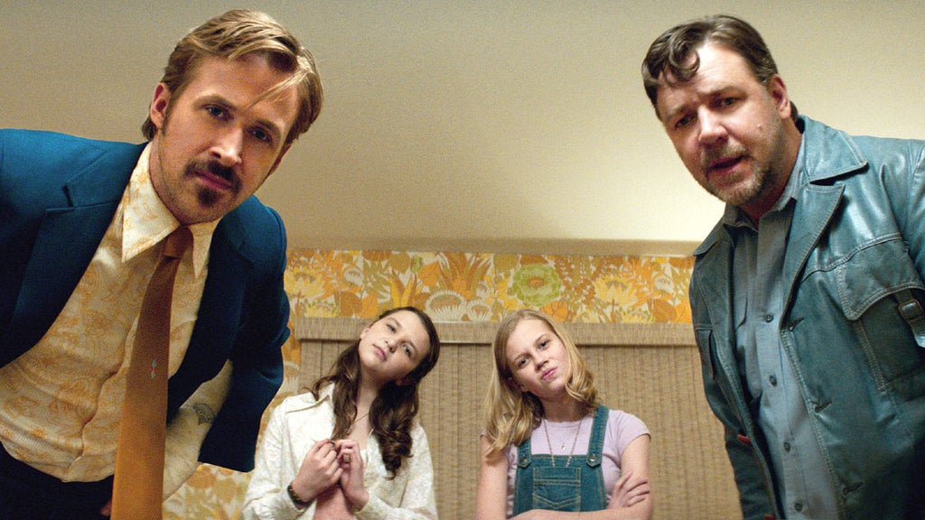 Two girls stand in between Ryan Gosling and Russell Crowe in "The Nice Guys."