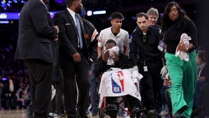 Tracy Morgan is taken off the court by medical staff in the third quarter of the game between the New York Knicks and the Miami Heat at Madison Square Garden on Monday. (Credit: Elsa/Getty Images)