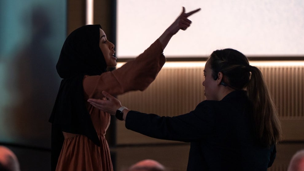 An unidentified protestor confronts Microsoft AI CEO Mustafa Suleyman during 50th anniversary event