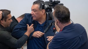 California Senator Alex Padilla is pushed out of the room as Homeland Security Secretary Kristi Noem holds a news conference in Los Angeles on June 12. (Credit: Getty Images)