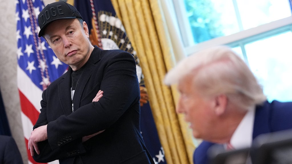 Tesla CEO Elon Musk listens as U.S. President Donald Trump speaks to reporters in the Oval Office of the White House on May 30, 2025 in Washington, DC