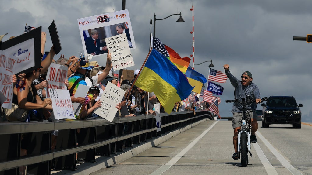 WEST PALM BEACH, FLORIDA - JUNE 14: Protesters march near President Donald Trump's Mar-a-Lago home during a "No Kings Day" protest on June 14, 2025 in West Palm Beach, Florida. Hundreds of marches and protests against the Trump administration are happening across the United States today in opposition to the military parade celebrating the 250th anniversary of the U.S. Army taking place in Washington, DC, ooinciding with President Trump's birthday. (Photo by Joe Raedle/Getty Images)