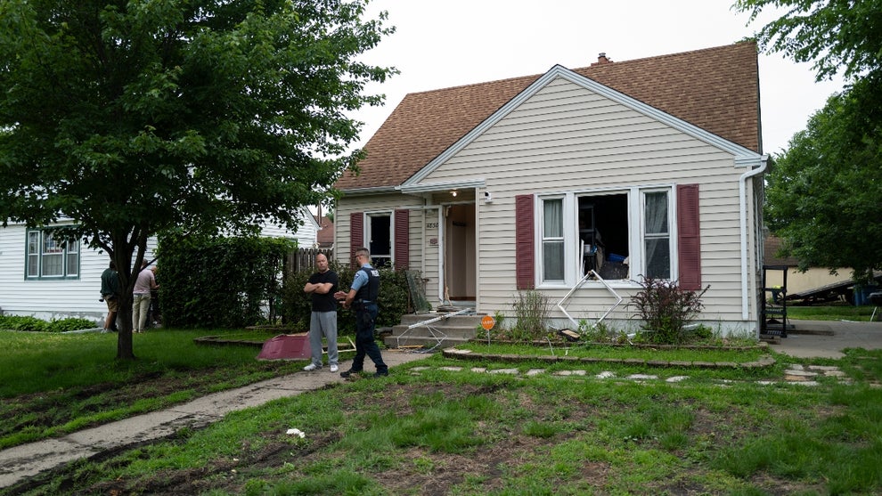 Vance Boelter's roommate, who declined to give his name, speaks with a Minneapolis police officer outside his home on June 14, 2025 in Minneapolis, Minnesota