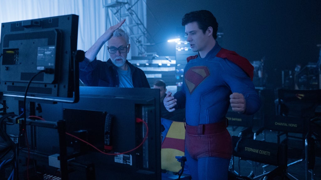James Gunn speaks to David Corenswet (in costume as Superman) at a monitor while filming "Superman"