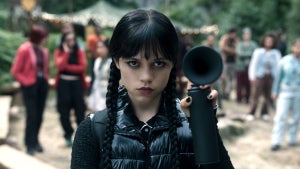 Jenna Ortega dresses in all black as Wednesday Addams while holding a black airhorn