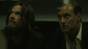 Jason Bateman (left) and Jude Law (right) stare to the left of the frame