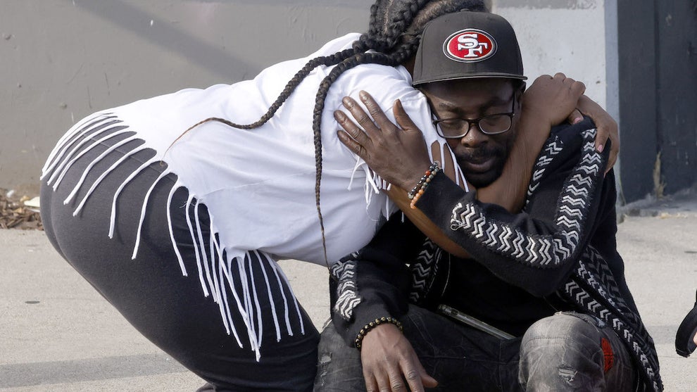 Judner Derisso, father to one of the deceased victims Gregory, is comforted by an onlooker at the scene of the Downtown L.A. shooting Monday morning. (Credit: Carlin Stiehl/Getty Images)