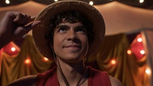 Iñaki Godoyholds the brim of his straw hat as Monkey D. Luffy