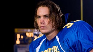 A young Taylor Kitsch wears a football uniform in the show "Friday Night Lights"