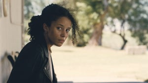Chase Infiniti sits on a bench in "One Battle After Another"