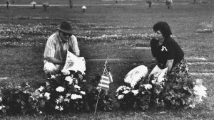 Barbara and Skip Suraci, the mother and stepfather of murder victims Jennifer and Sarah Harbison, visiting the flower-covered graves of their daughters who were shot to death at the end of their working shift at a yogurt shop. (Photo by Mark Perlstein/Getty Images)
