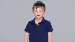 A young Jewish boy addresses the camera while wearing a yarmulke in a video for the "Like a Jew" campaign