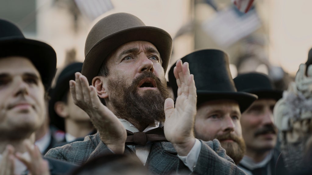 Matthew Macfadyen claps in a crowd in "Death by Lightning" (Netflix)