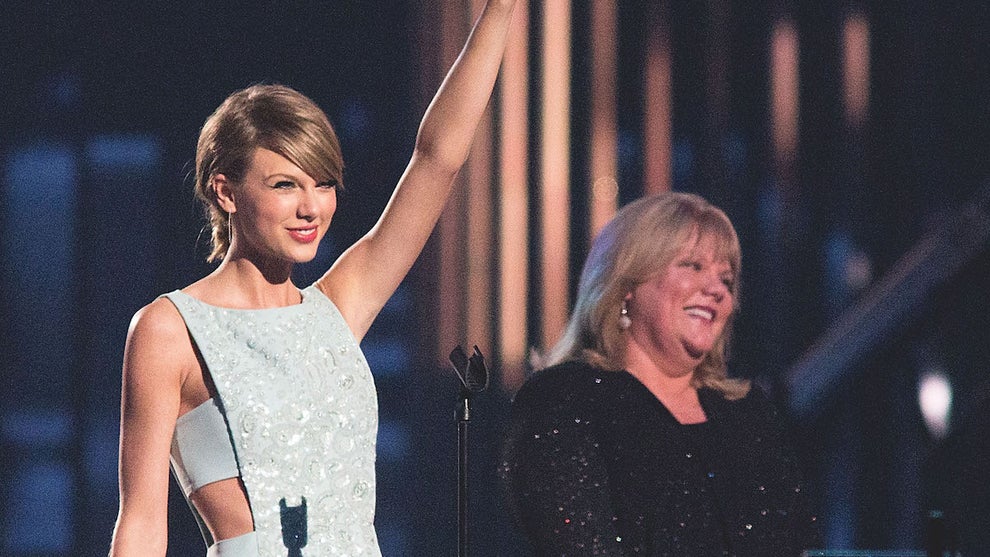 Taylor Swift accepts the Milestone Award from Andrea Swift onstage during the 50th Academy of Country Music Awards in 2015. (Rick Kern/WireImage)