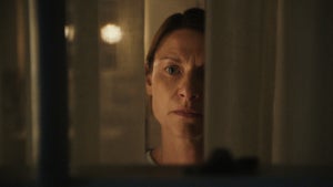 Claire Danes peers through a window in the trailer for "The Beast in Me" (Credit: Netflix)