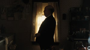 Tom Hollander as Alfred Hitchcock, seen in silhouette in "Monster: The Ed Gein Story"