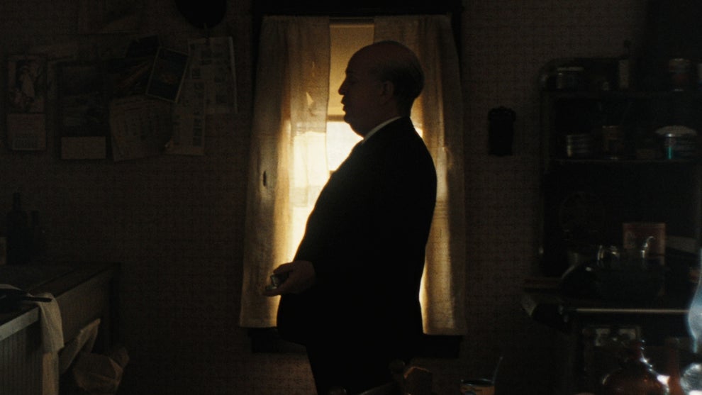 Tom Hollander as Alfred Hitchcock, seen in silhouette in "Monster: The Ed Gein Story"