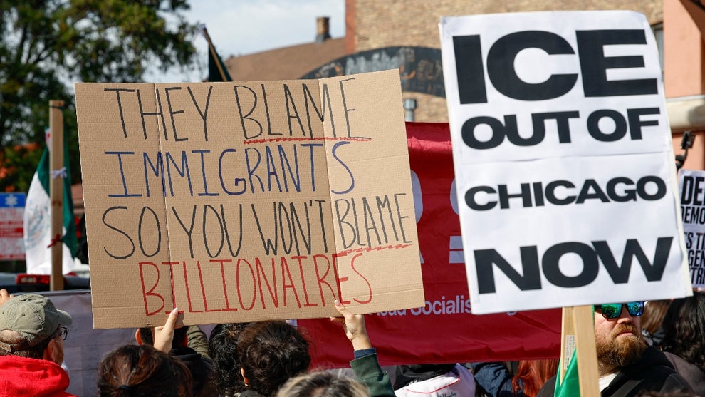 Protesters hold signs against Immigration and Customs Enforcement during the "ICE and DHS Out of Little Village" demonstration at the predominantly Mexican-American neighborhood of Little Village, also known as "La Villita", in Chicago, Illinois on October 25, 2025