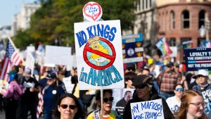 Protesters march down Pennsylvania Avenue NW for the second "No Kings" protest in Washington on Saturday, October 18, 2025 in Washington, DC