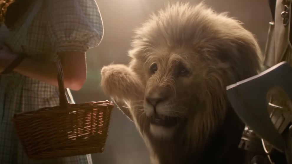 The Cowardly Lion cowers behind Dorothy and the Tin Man in "Wicked: For Good"