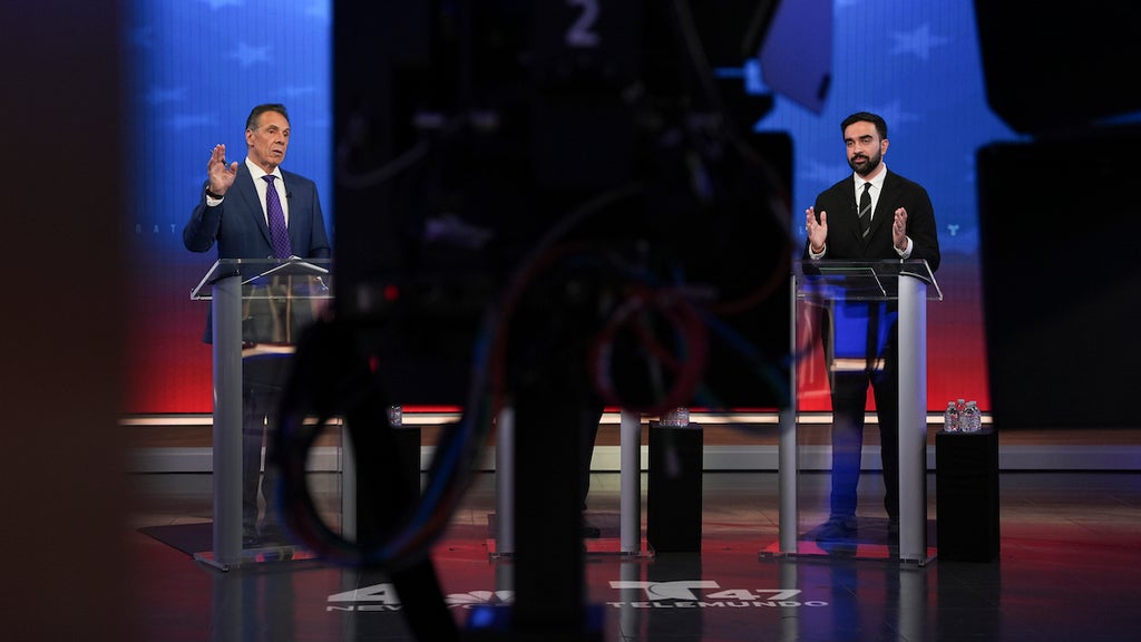 Andrew Cuomo and Zohran Mamdani speak during a mayoral debate at Rockefeller Center on Oct. 16, 2025. (Angelina Katsanis-Pool/Getty Images)