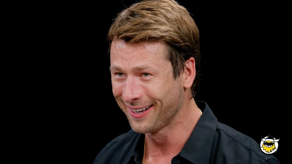 Glen Powell smiles on "Hot Ones"