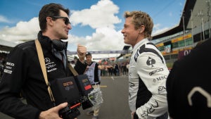 Joseph Kosinski talks to Brad Pitt on the racetrack while filming "F1"