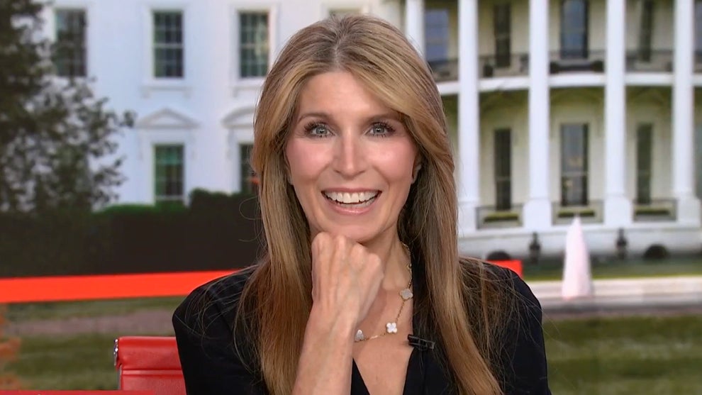 Nicolle Wallace smiles into the camera in front of a White House backdrop on MSNBC