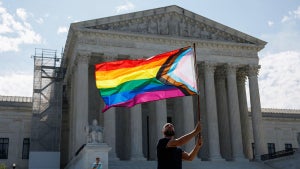 Same-sex marriage supporter Vin Testa, of Washington, DC, waves a LGBTQIA pride flag in front of the U.S. Supreme Court Building (Credit: Anna Moneymaker/Getty Images)