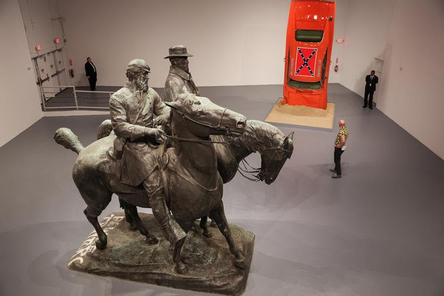 (L/R) A statue of Confederate generals Robert E. Lee and Thomas "Stonewall" Jackson, which was removed from Baltimore, Maryland in 2017, alongside artist Hank Willis Thomas’ sculpture A Suspension of Hostilities, are displayed at the Monuments exhibition at The Geffen Contemporary at MOCA in Los Angeles. Source: Getty