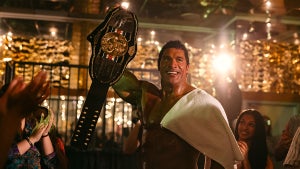 Dwayne Johnson holds up a championship belt in "The Smashing Machine"