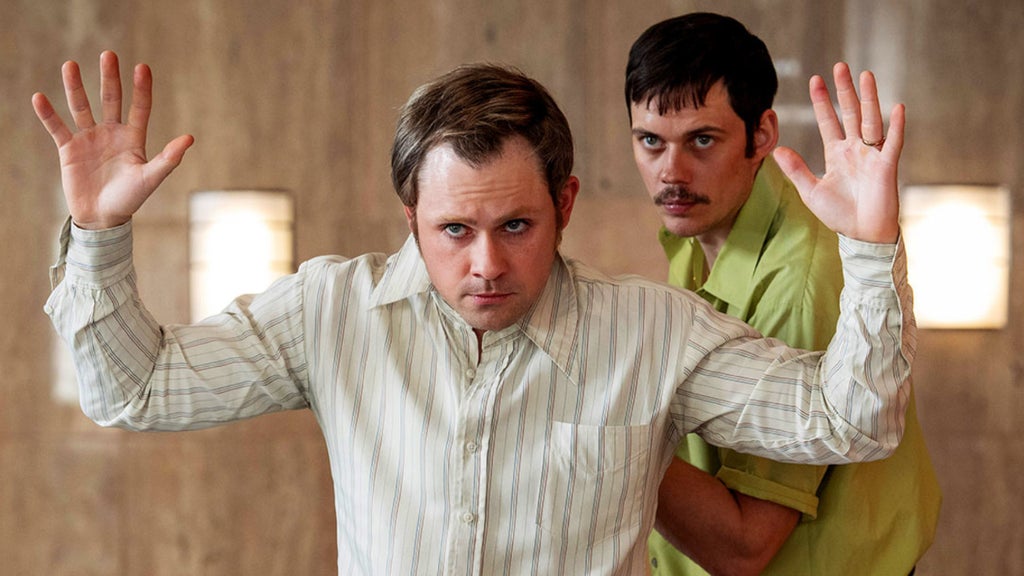 Dacre Montgomery and Bill Skarsgård in "Dead Man's Wire" (Row K Entertainment)