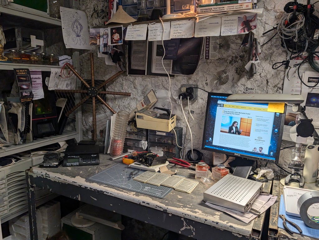 A computer and wall full of evidence from "Bugonia"
