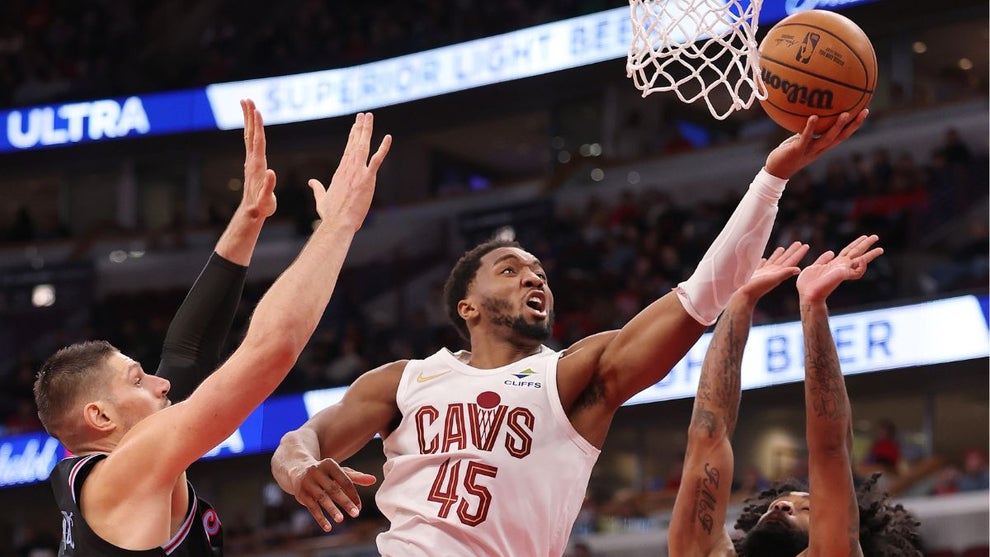 Donovan Mitchell #45 of the Cleveland Cavaliers goes up for a layup against Nikola Vucevic #9 and Coby White #0 of the Chicago Bulls during the second half at the United Center on December 17, 2025 in Chicago, Illinois. (Credit: Getty Images)