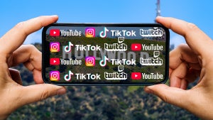 Someone taking an image of the Hollywood sign on their iPhone