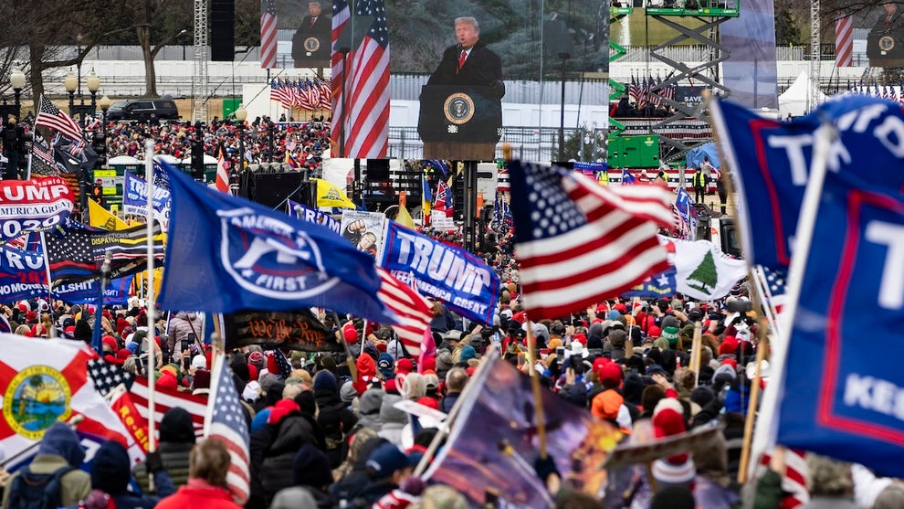 President Donald Trump is seen on a screen as his supporters cheer during a rally on the National Mall on January 6, 2021 in Washington, DC. Trump supporters gathered in the nation's capital today to protest the ratification of President-elect Joe Biden's Electoral College victory over President Trump in the 2020 election. (Credit: Samuel Corum/Getty Images)